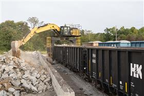 Dagsboro Stone Depot: A Caterpillar 336F Straddle Carrier unloads gondola railcars at Dagsboro Stone Depot.