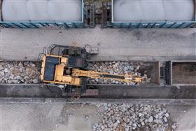 Dagsboro Stone Depot: A Caterpillar 336F Straddle Carrier unloads gondola railcars at Dagsboro Stone Depot.