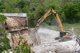 Demolition: A Haines & Kibblehouse excavator processes an old bridge. 