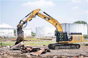Demolition: A Caterpillar 349F uses a shear to process scrap on a demolition site. 